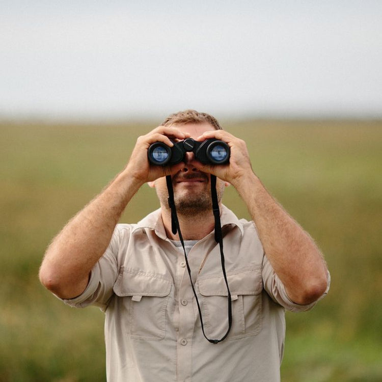 Man looking through binoculars